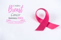 Pink ribbon on white paper background for supporting breast cancer Royalty Free Stock Photo