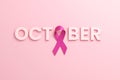 Pink ribbon and the word October on a pink background for the Breast Cancer Awareness Month and World Cancer Day. Flyer design Royalty Free Stock Photo