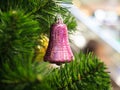 Pink ring bell hanging on Christmas tree