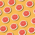 Pink ripe grapefruit slices on the orange background pattern Royalty Free Stock Photo