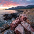Pink rocks on the coast at sunset Royalty Free Stock Photo