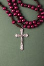 Pink Rosary on a green background.
