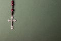 Pink Rosary on a green background. Royalty Free Stock Photo