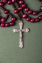 Pink Rosary on a green background. Royalty Free Stock Photo