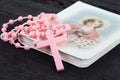 Pink rosary over a religious book Royalty Free Stock Photo