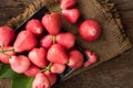 Pink rose apple on wood table