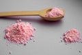 Pink rose bath salt with wooden spoon on lilac background. Aroma spa concept. Aromatherapy. Royalty Free Stock Photo