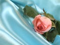 Pink rose on blue satin Royalty Free Stock Photo