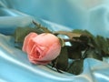 Pink rose on blue satin Royalty Free Stock Photo