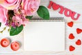 Pink rose bouqet and red heart on white wooden background. Royalty Free Stock Photo