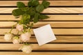 Pink rose bouquet closup and sticker note on a wooden bench Royalty Free Stock Photo