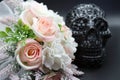 Baby pink roses with lacey scull in background