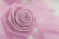 Pink rose fabric flower and small hart on white background