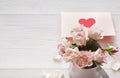 Pink rose flowers bouquet and handmade greeting card on white rustic wood Royalty Free Stock Photo