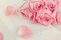Pink rose flowers with pink petal rose on opened book Royalty Free Stock Photo