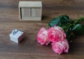 Pink rose fresh flowers on a wooden background