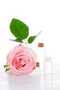 Pink rose and glass bottles with transparent liquid Royalty Free Stock Photo