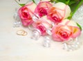Pink rose ribbon and wedding rings on wood white Royalty Free Stock Photo