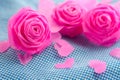 Pink rose and small hart on blue cloth background