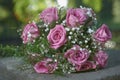 Pink rose wedding bouquet with two gold ring