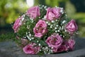 Pink rose wedding bouquet with two gold ring