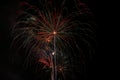 Fireworks bursting in a clear dark night sky Royalty Free Stock Photo