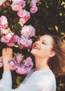 Pink rosebush blooming. Happy woman walking at rose garden. Relaxing and happiness concept. Young smiling girl enjoys Royalty Free Stock Photo