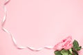Pink Roses anf ribbon with littke hearts on penk background Card for 8 March, woman day. Copy space, mock up, banner