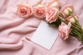 Pink roses with blank card on draped satin fabric Royalty Free Stock Photo