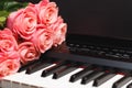 Pink roses bouquet on electric piano keys Royalty Free Stock Photo