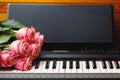 Pink roses bouquet on electric piano keys Royalty Free Stock Photo