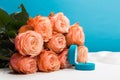 Pink roses and box holding wedding ring on blue background Royalty Free Stock Photo