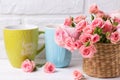 Pink roses flowers and colorful green and blue cups against Royalty Free Stock Photo