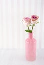 Pink roses in a glass bottle on wooden background Royalty Free Stock Photo