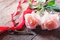 Pink roses and Love key shape on vintage wooden floor under soft warm light. Backdrop for Valentine's day Royalty Free Stock Photo