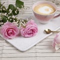 Pink roses on marble plate with pink coffee cup Royalty Free Stock Photo