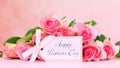 Pink roses on pink wood table, Mother`s Day background closeup.