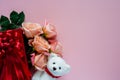 Pink roses in red gift box with white teddy bear doll on pink background Royalty Free Stock Photo