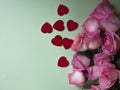 Pink roses, red hearts on green background. Valentines day background. Royalty Free Stock Photo