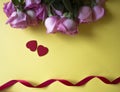 Pink roses, red hearts and red ribbon on yellow background. Valentines day background. Royalty Free Stock Photo