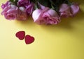 Pink roses, red hearts on yellow background. Valentines day background. Royalty Free Stock Photo