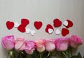 Pink roses, red and white hearts over wooden background. Valentines day background. Royalty Free Stock Photo