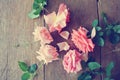 Pink roses on the rustic wooden table; retro, filtered Royalty Free Stock Photo