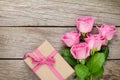 Pink roses and valentines day gift box over wooden table Royalty Free Stock Photo