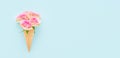 Pink roses in a waffle ice cream cone on a blue background. Summer concept, banner Royalty Free Stock Photo