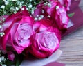 Pink roses on a wooden background. Romantic background Royalty Free Stock Photo