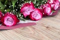 Pink roses on a wooden background. Romantic background Royalty Free Stock Photo