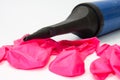 Pink rubber balloons and inflatable pump Royalty Free Stock Photo