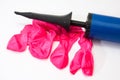 Pink rubber balloons and inflatable pump Royalty Free Stock Photo