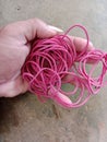 pink rubber bands in the form of elastic rings, women& x27;s and children& x27;s accessories are in the palm of the hand Royalty Free Stock Photo